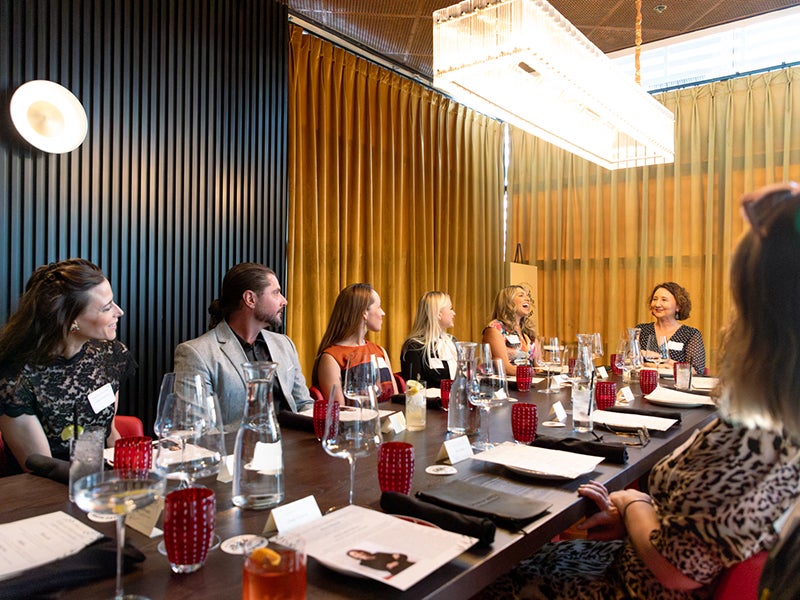 A group sits at an award ceremony dinner.