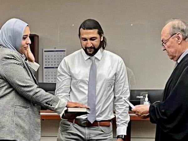 Laila Ikram standing in courtroom during her swearing in ceremony