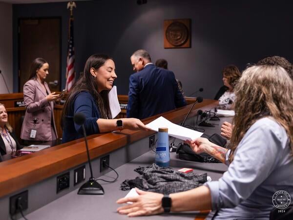 woman handing over paper