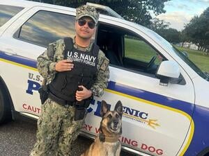 man in military uniform with dog